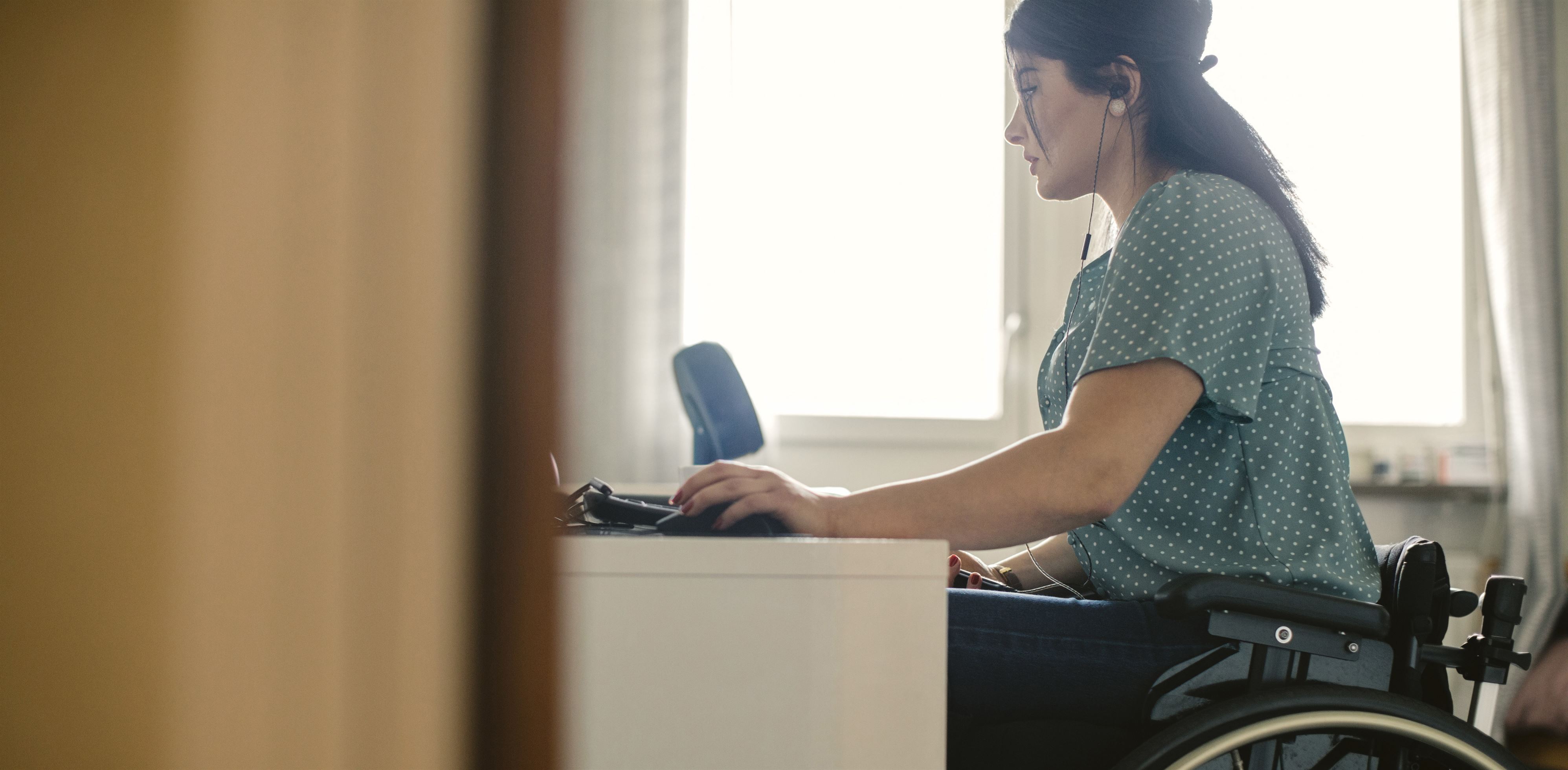 Woman in wheelchair works on computer