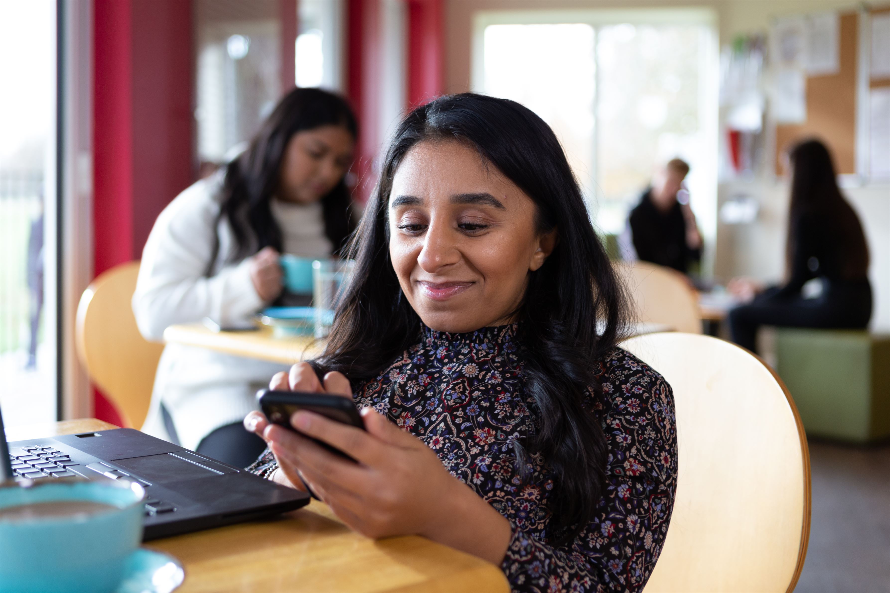 Woman smiles at her phone screen