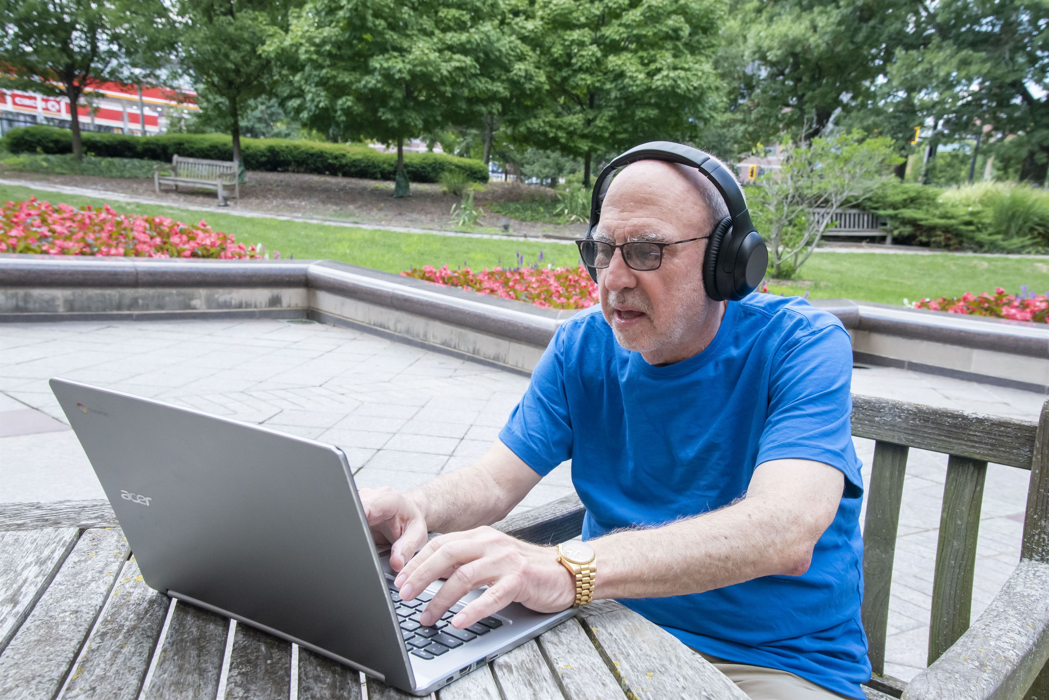 Man wearing headphones types